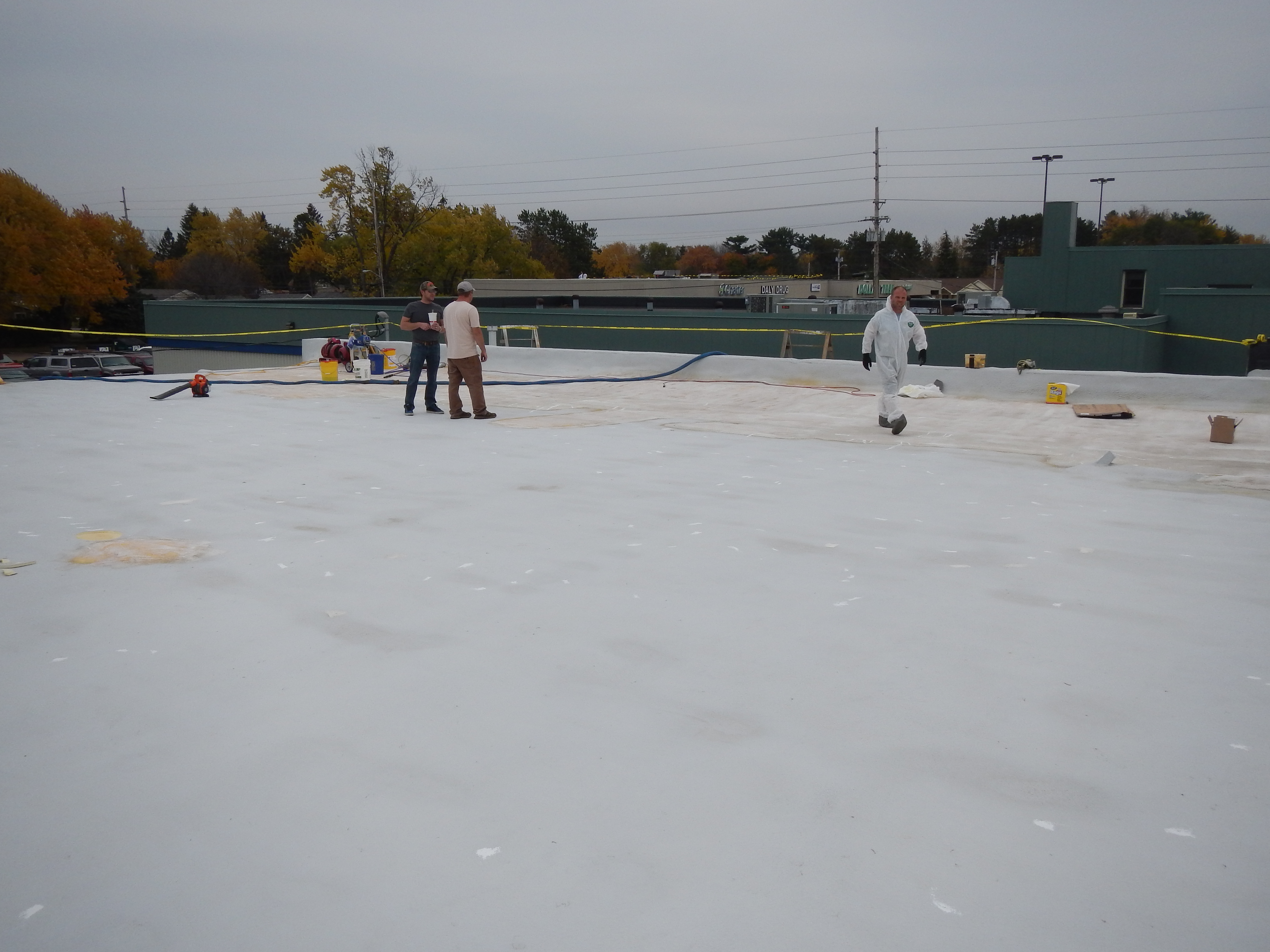 Roof membrane primed ahead of polyurea coating